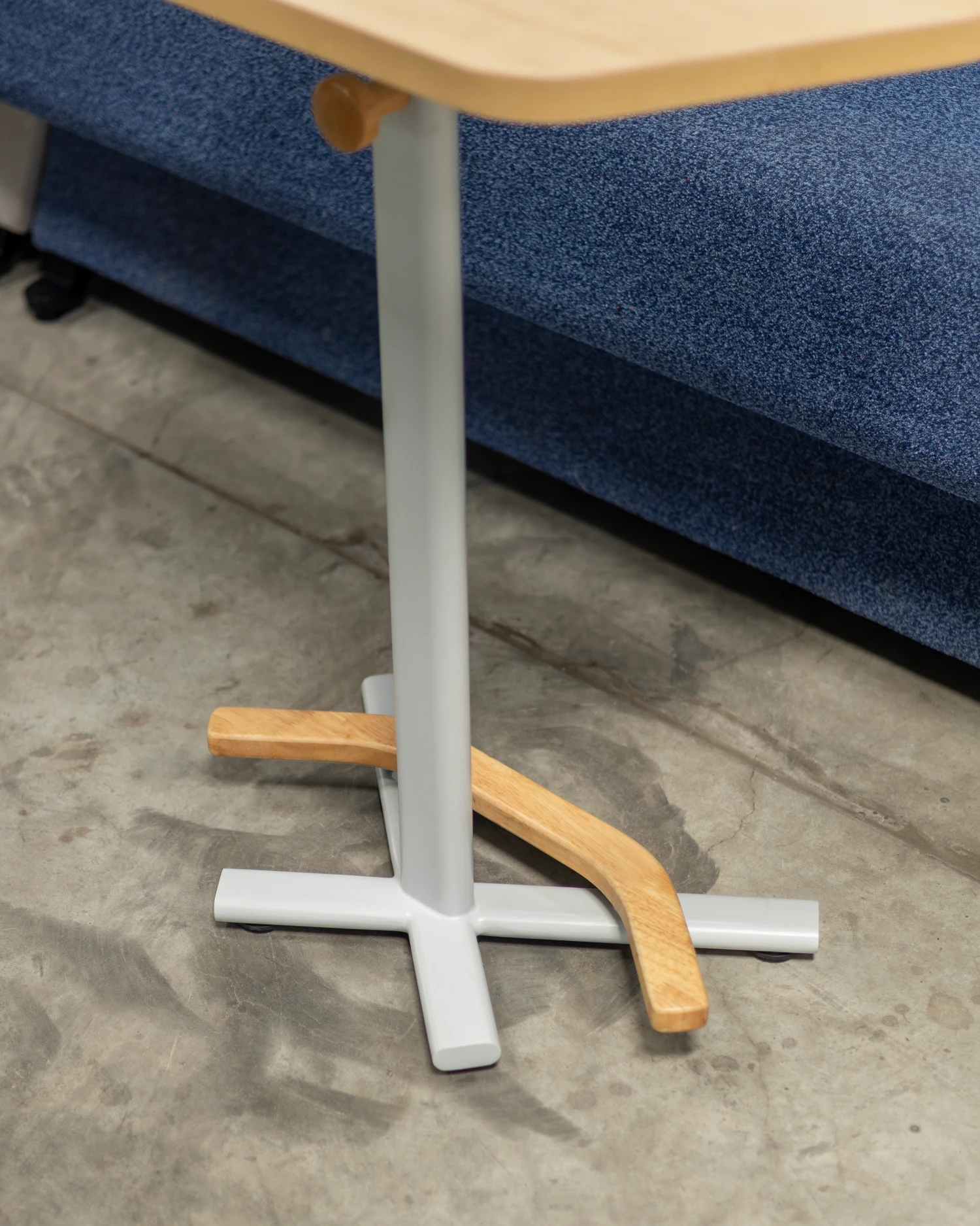 Attuny mono architectural base detail with solid wood footrest and steel support column