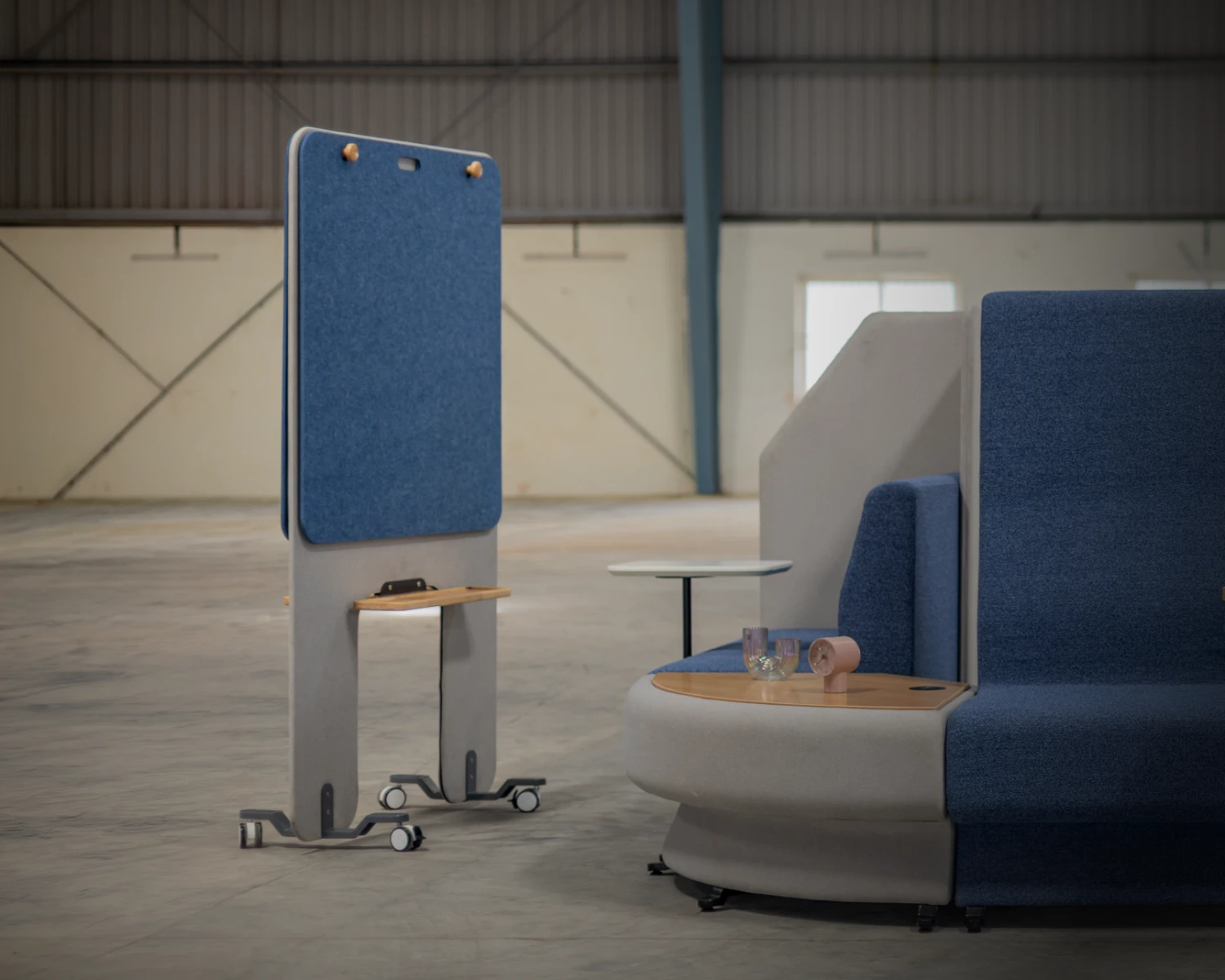 Attuny screen mobile acoustic pinboard standing next to blue sync booth