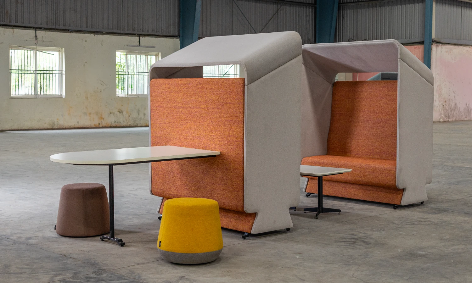 Attuny sync sheltered meeting booth with conference worktable and mobile ottomans